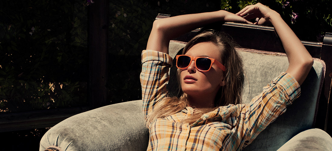 Young Woman With Orange Glasses Lounging